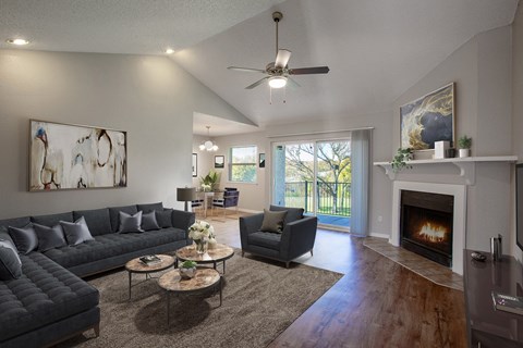 a living room with couches and chairs and a fireplace